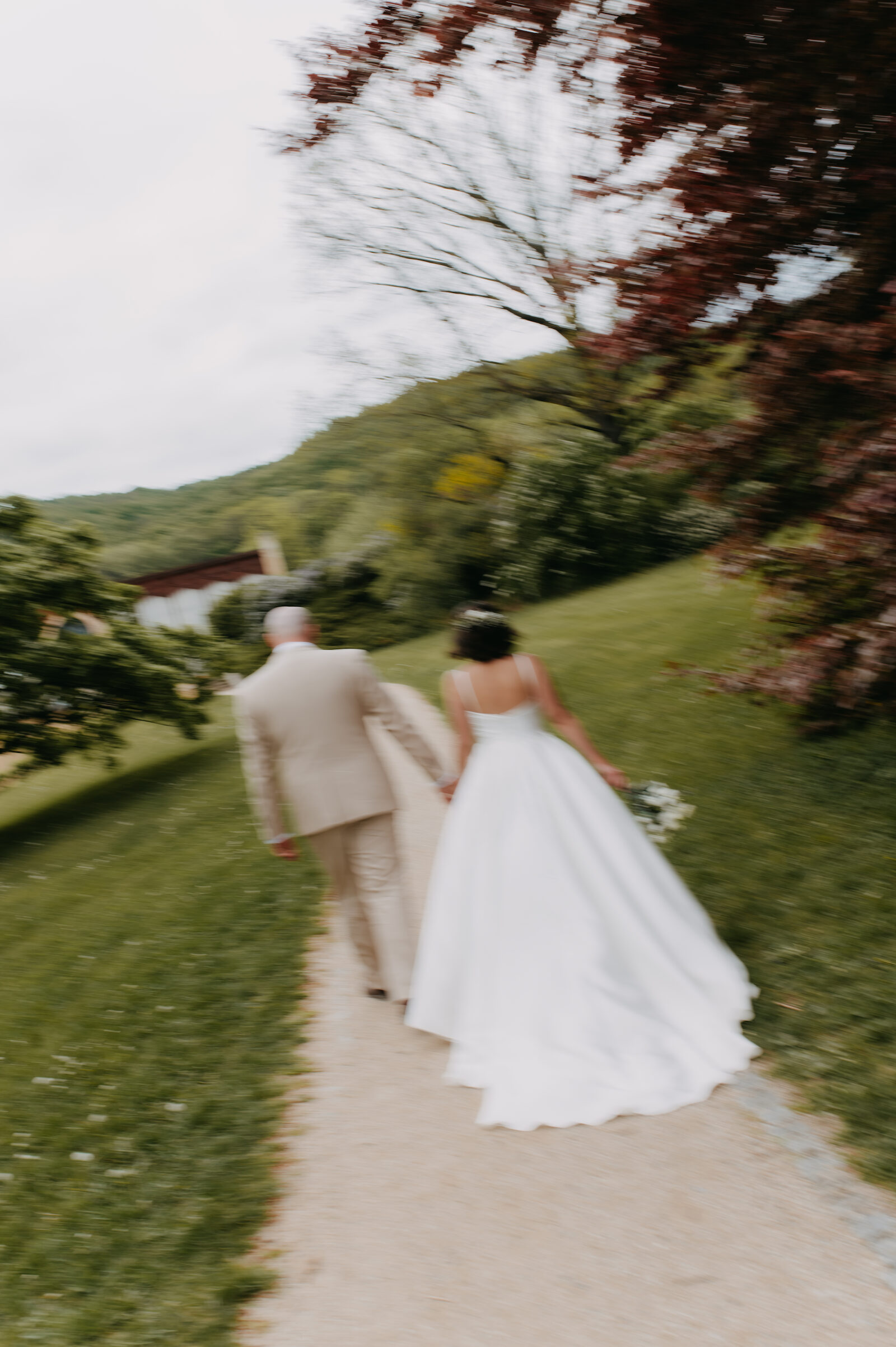 Wedding dress in motion on a garden path